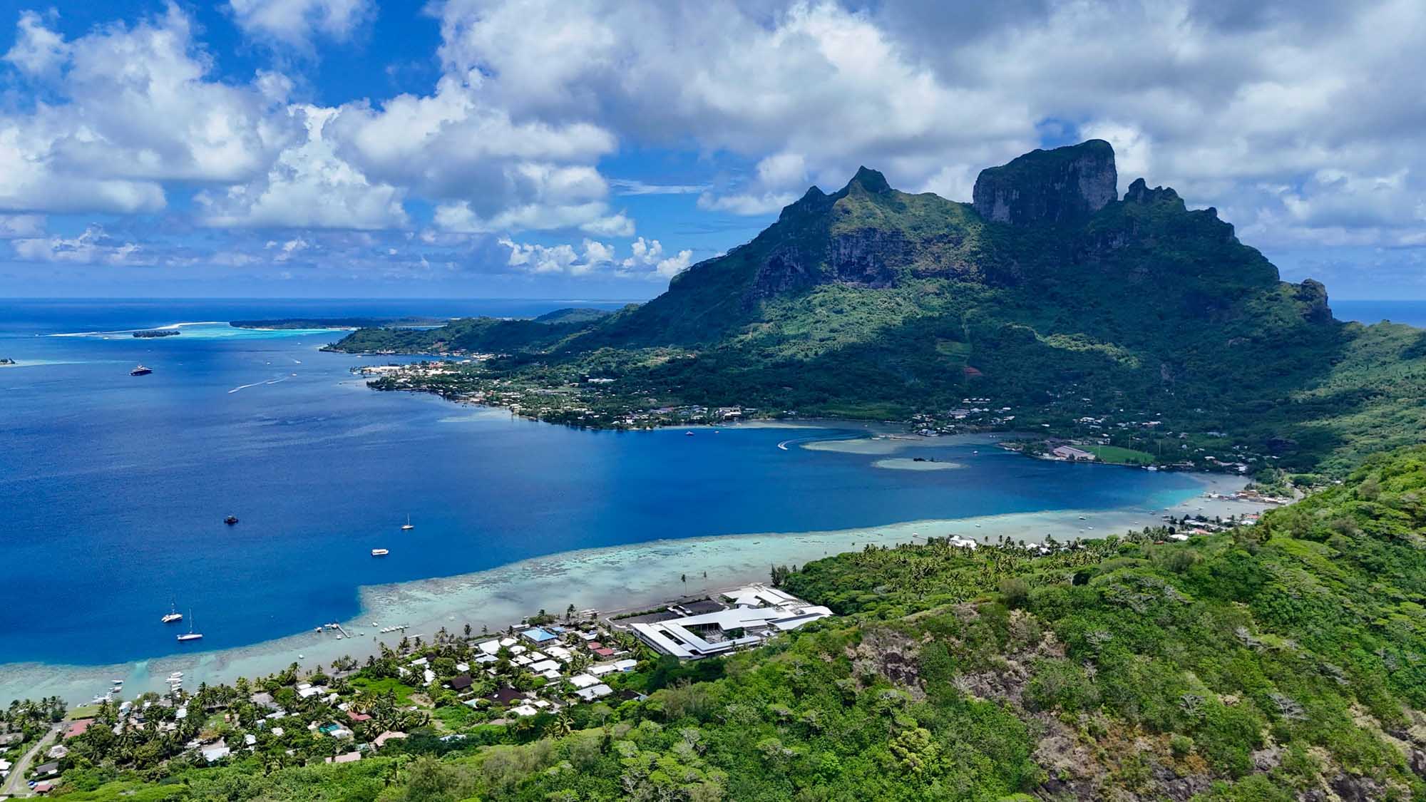 An aerial view of Bora Bora, French Polynesia, showcasing the iconic dramatic volcanic peak