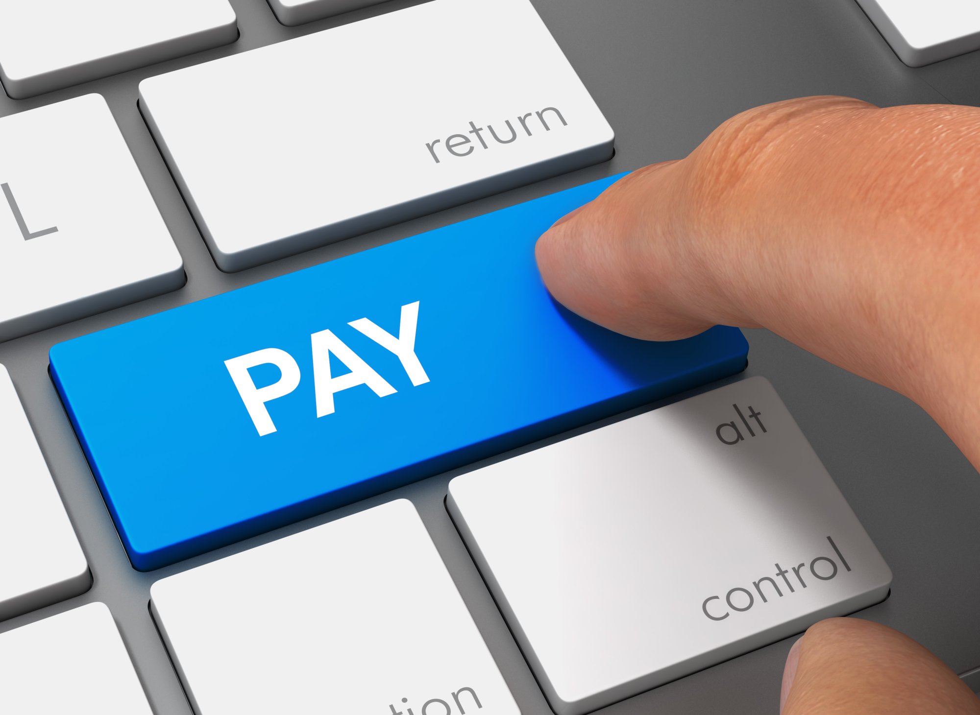 A close-up photograph of a human finger pressing a bright blue 'PAY' key on a computer keyboard