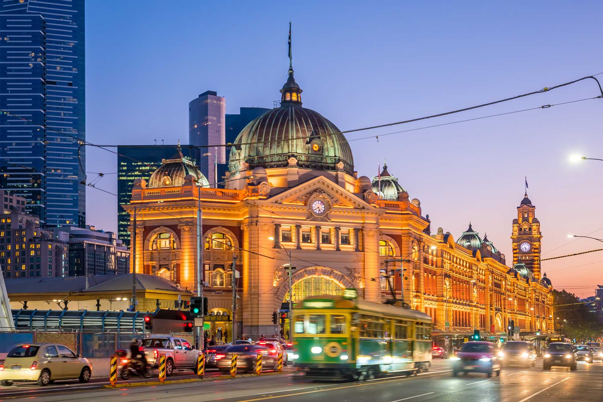 The iconic Flinders Street Train Station in Melbourne, Australia, illuminated by golden evening