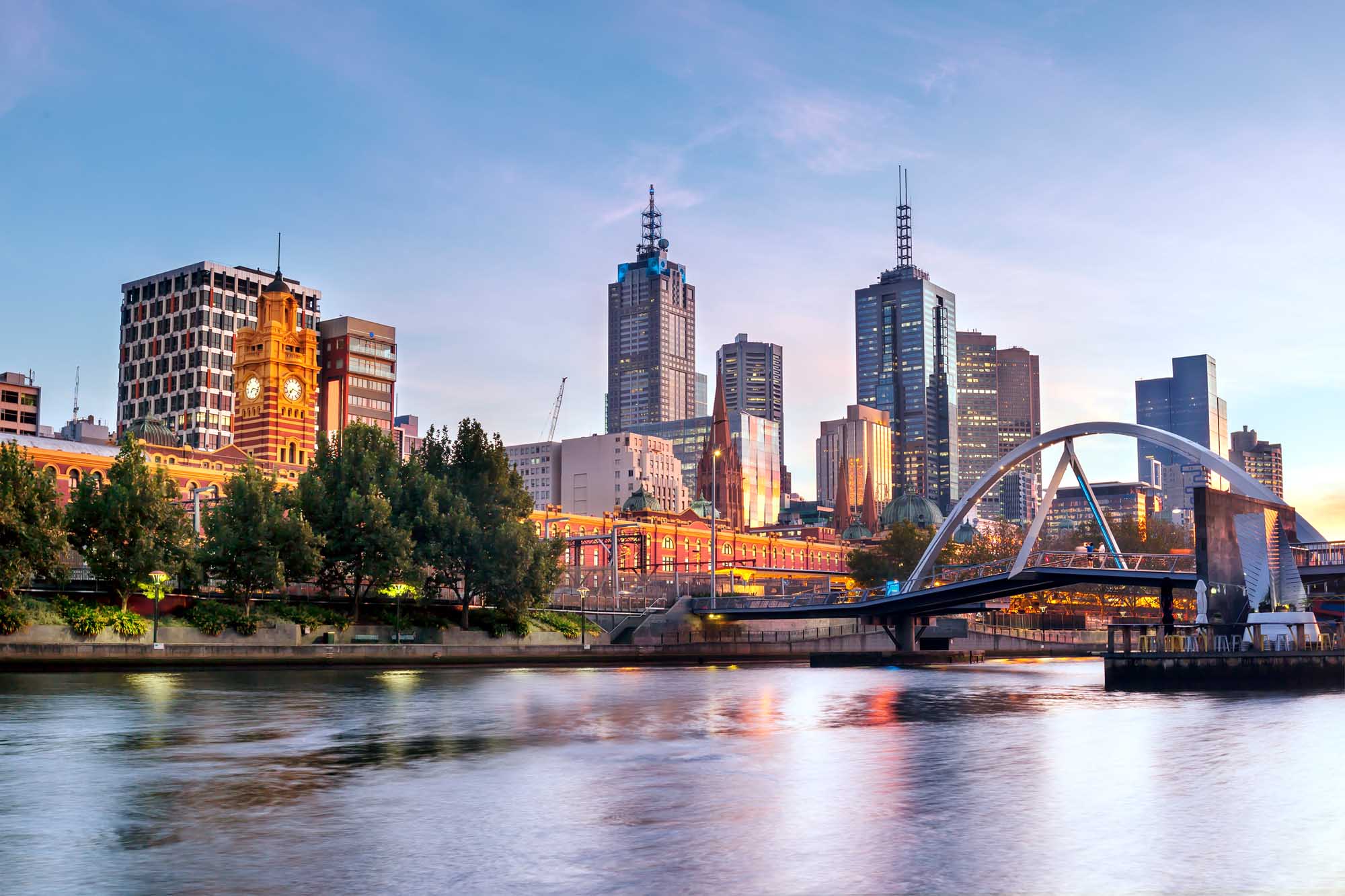A stunning early morning cityscape of Melbourne, Australia, featuring the illuminated skyline