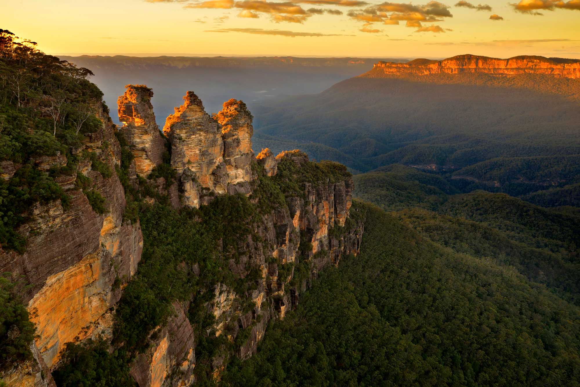 A stunning sunrise view of the iconic Three Sisters rock formation in the Blue Mountains of New