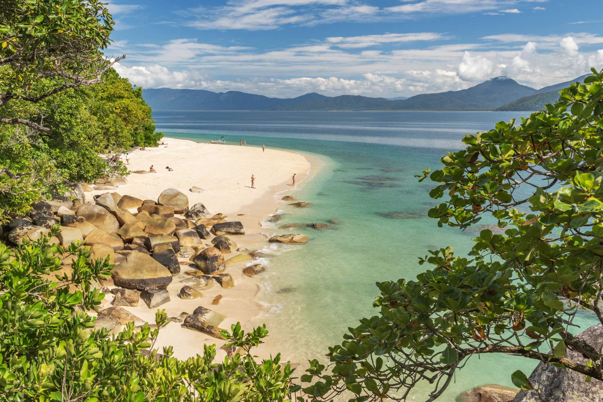 istock-2162510923 A pristine tropical beach with powdery white sand and turquoise waters, framed by lush green
