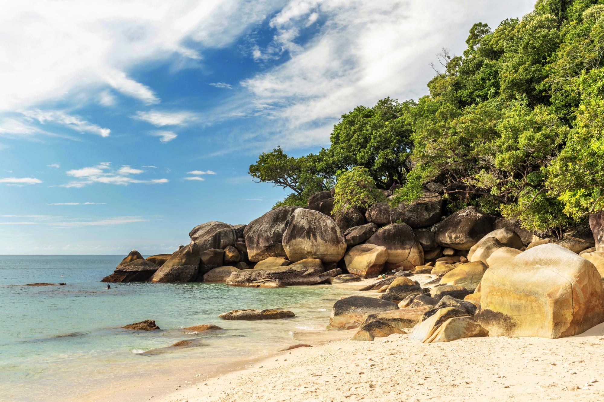 istock-2180973514 A pristine tropical beach featuring dramatic granite rock formations and boulders scattered along