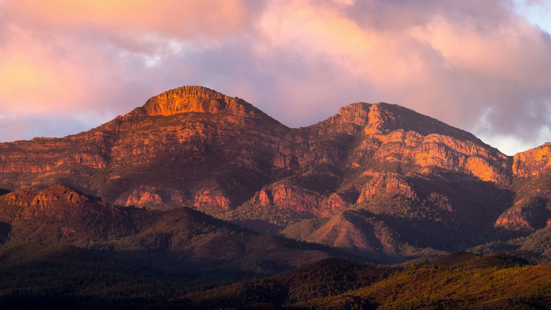 Flinders Ranges Mountain Peaks at Sunset Dramatic rocky mountain peaks of the Flinders Ranges bathed in golden-orange alpenglow at sunset