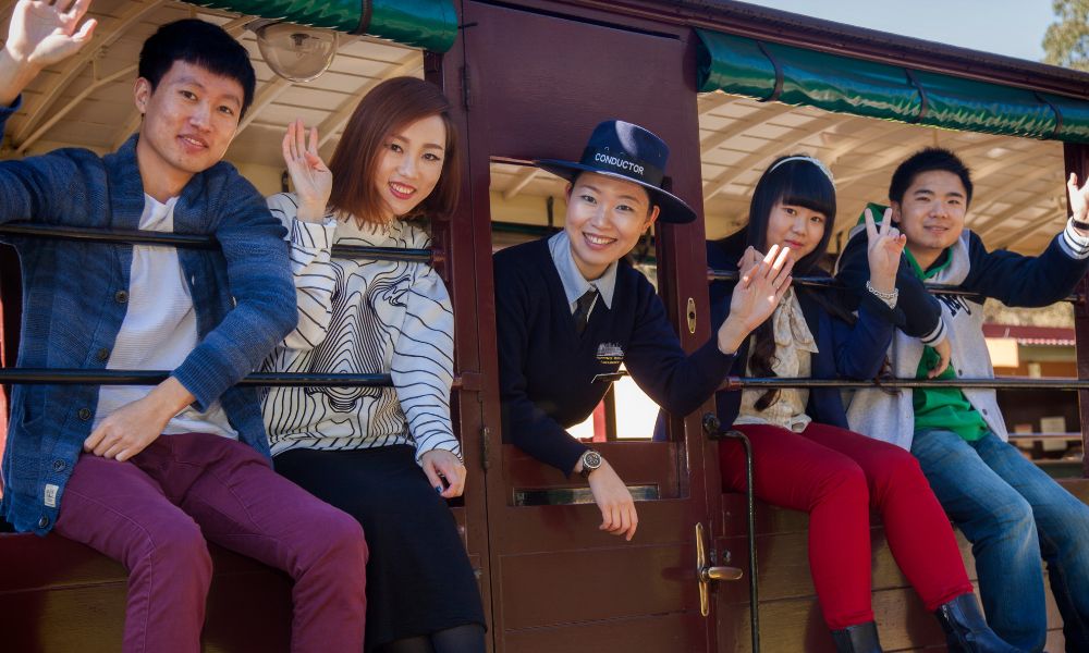 Guests Enjoying Time with Train Conductor Guests enjoying with conductor