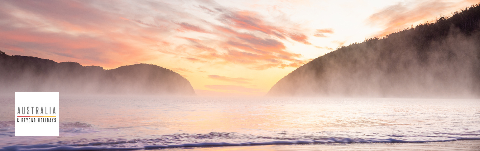 A serene early morning scene of a misty beach with gentle waves rolling onto the shore, framed