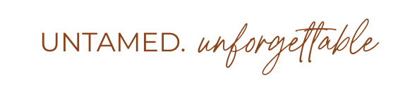 A minimalist text-based graphic featuring the words "UNTAMED. unforgettable" in an elegant serif