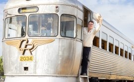 Vintage Streamliner Train with Passengers Boarding A classic mid-century streamliner passenger train with distinctive silver aluminum exterior and Art