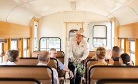 Vintage Tour Bus Interior with Passengers Interior of a classic tour or charter bus with wooden paneling and vintage seating, showing