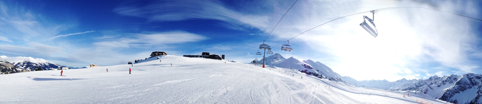 A pristine ski resort nestled in the Alps features expansive white slopes with groomed ski runs